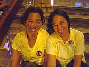 Elizabeth Tundag (left) and Pricella Gealon try to cheer up despite their exhaustion during the last day of Cory Aquino's wake.